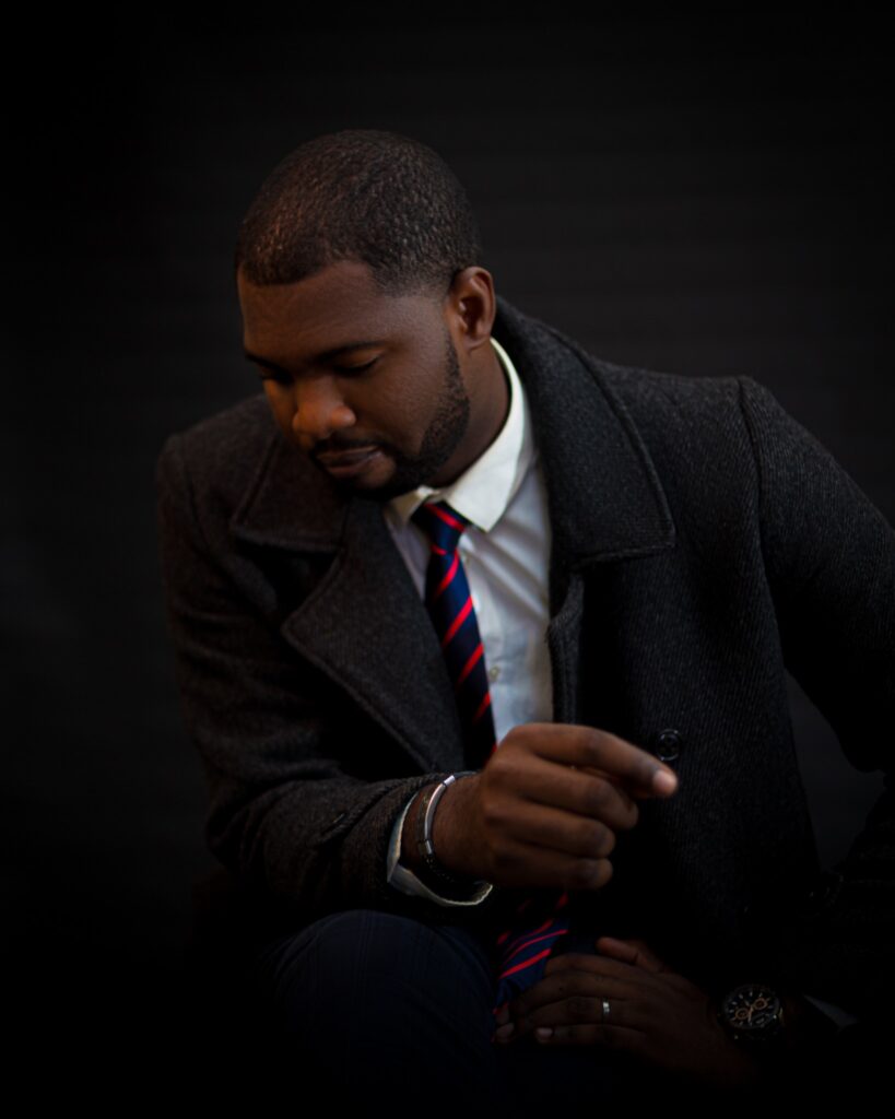 Abraham Ologundudu, portrait in a coat