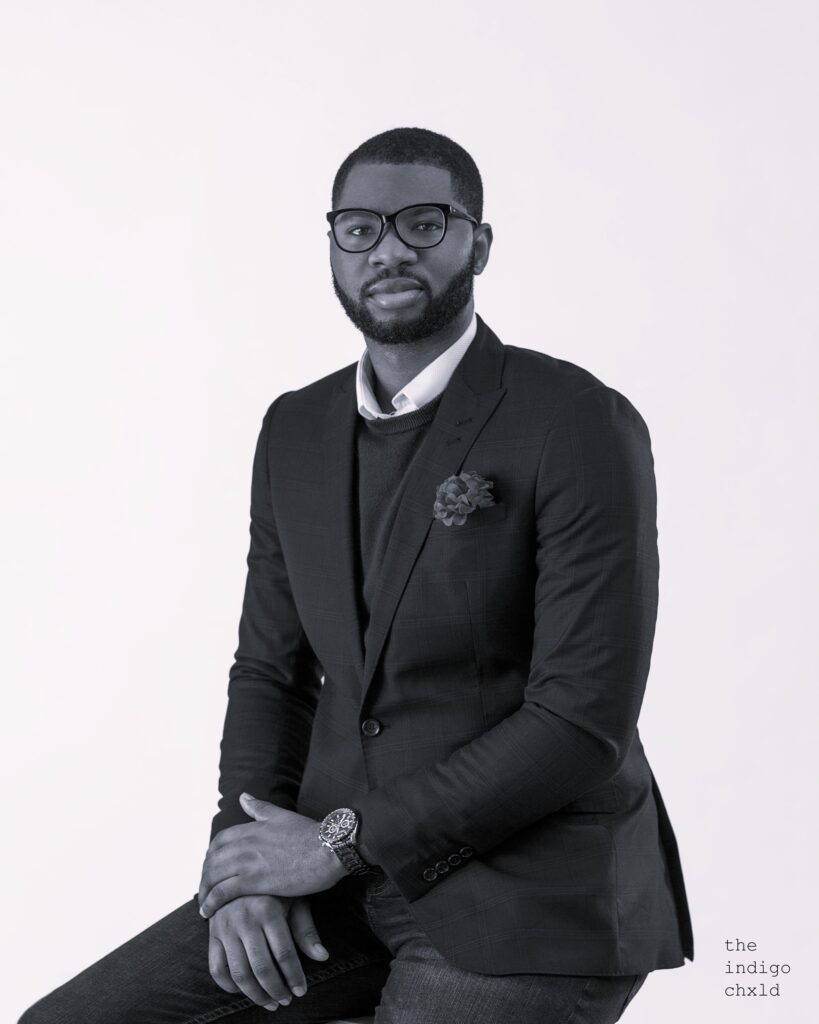 Abraham Ologundudu, portrait, seated (black and white)