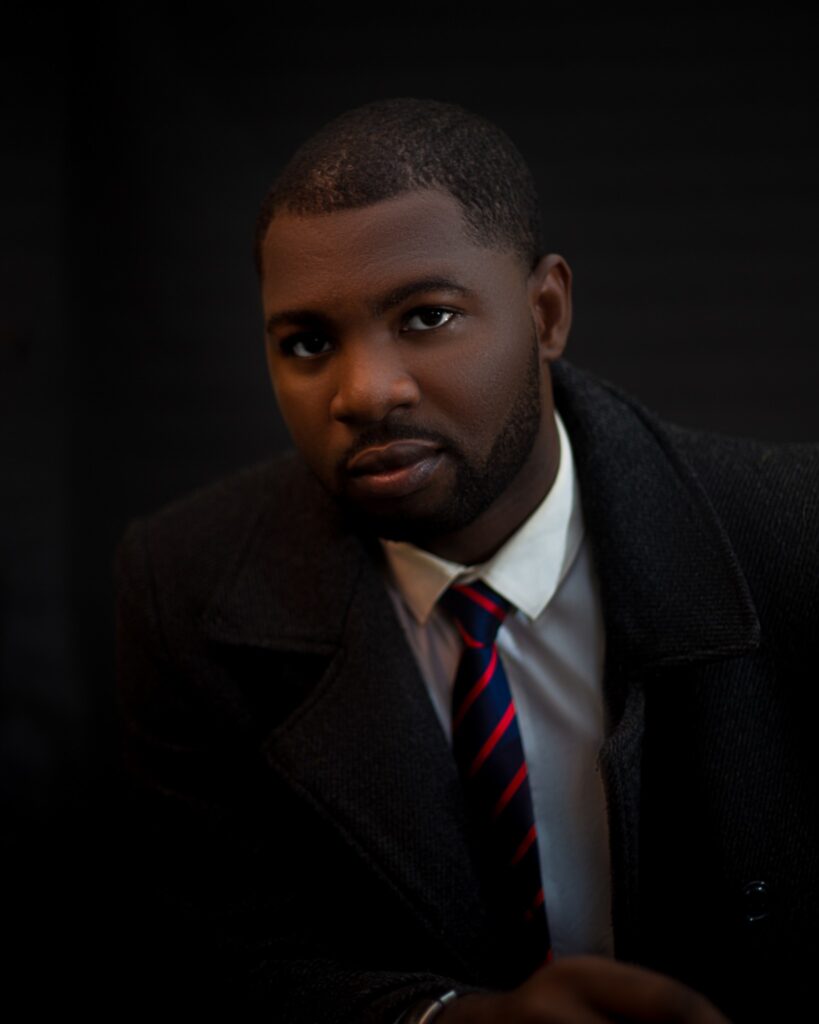 Abraham Ologundudu, portrait in a coat and tie